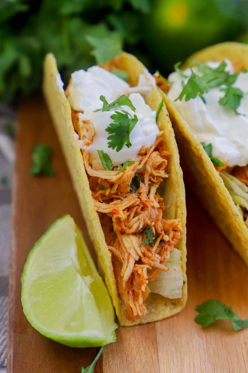 Slow Cooker Cilantro Lime Chicken Tacos closeup on wooden board