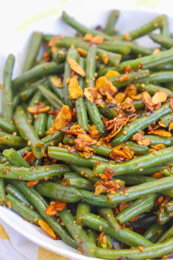 topping green beans with the toasted almonds