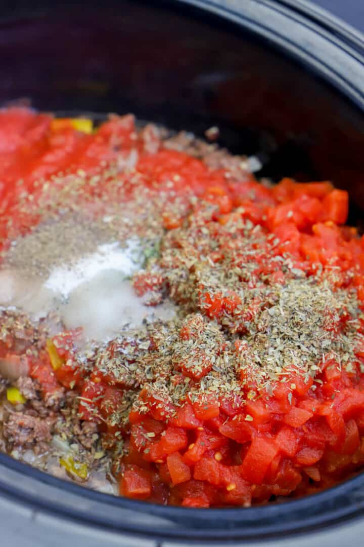 adding spices to the slow cooker