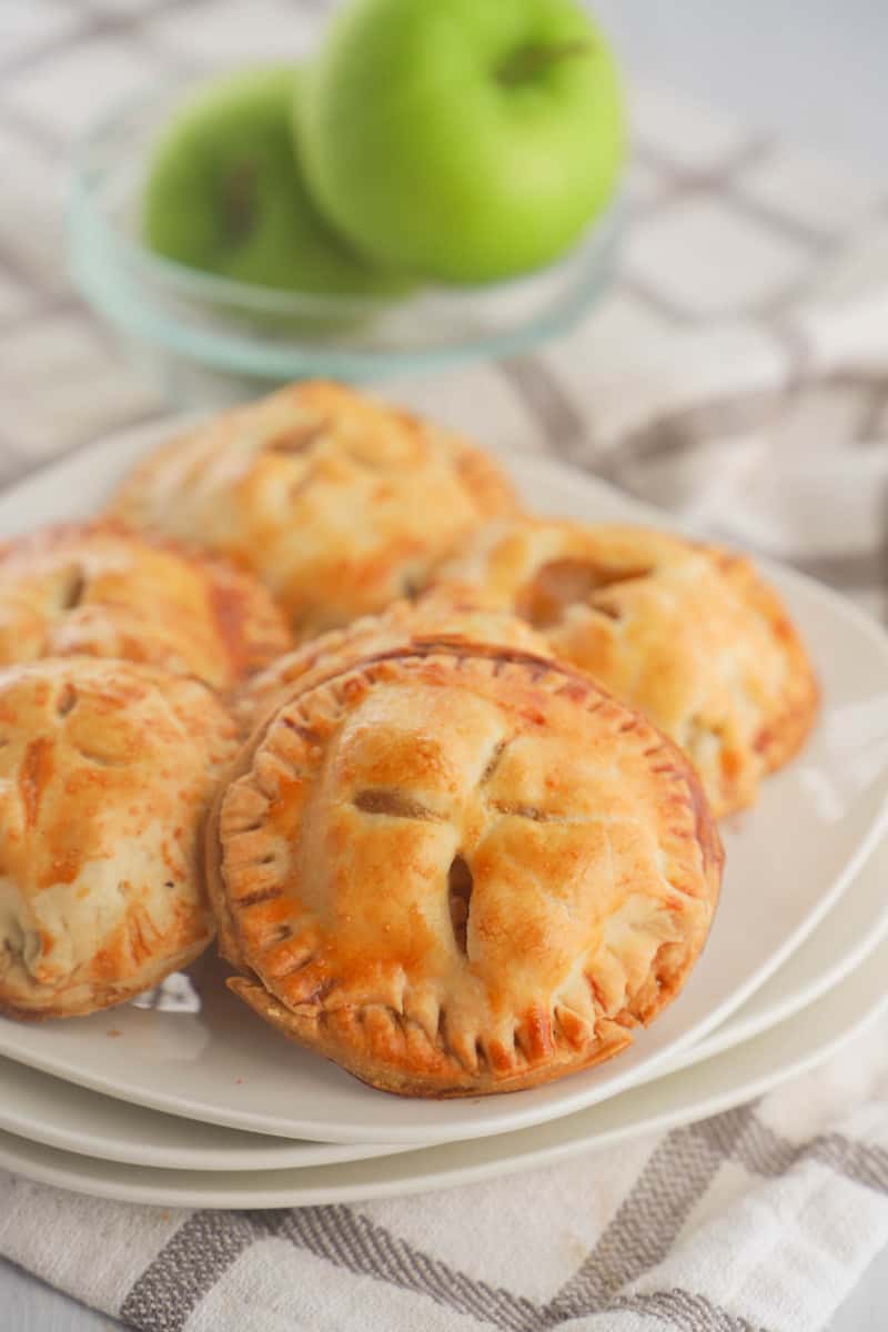 apple pie cookies on stacked white plates