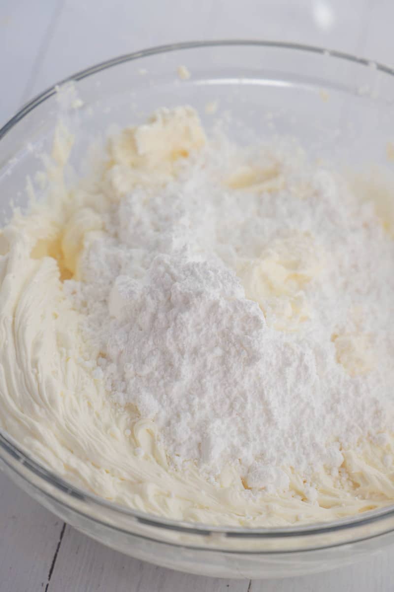 adding powdered sugar to the cream cheese mix