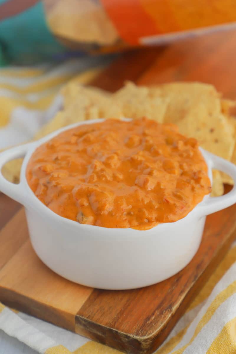 Cheesy Salsa Dip in white serving bowl on wooden tray