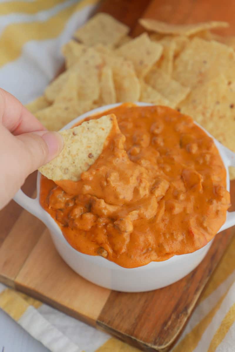 close up of cheesy salsa dip on a tortilla chip