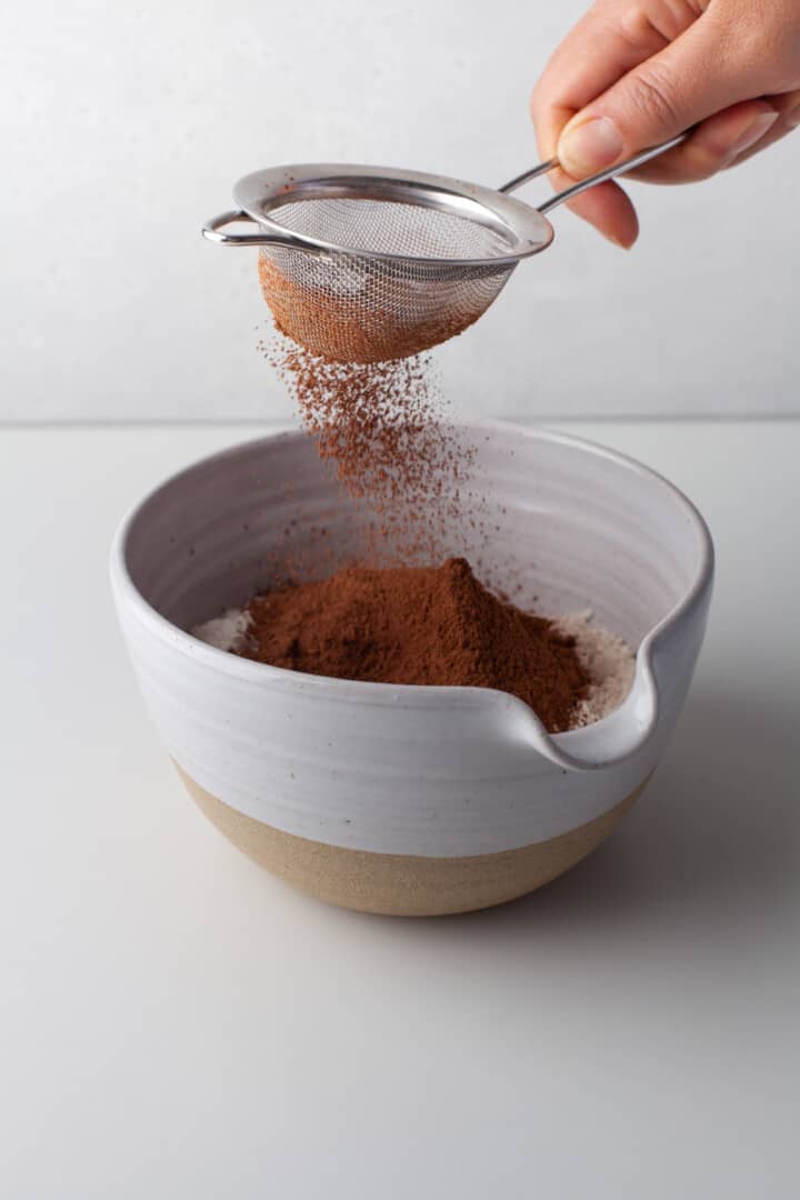 sifting together the dry ingredients for cookies