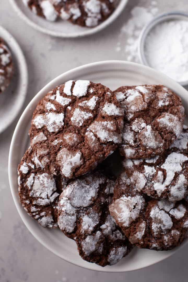 closeup of chocolate crinkle cookies on white stand