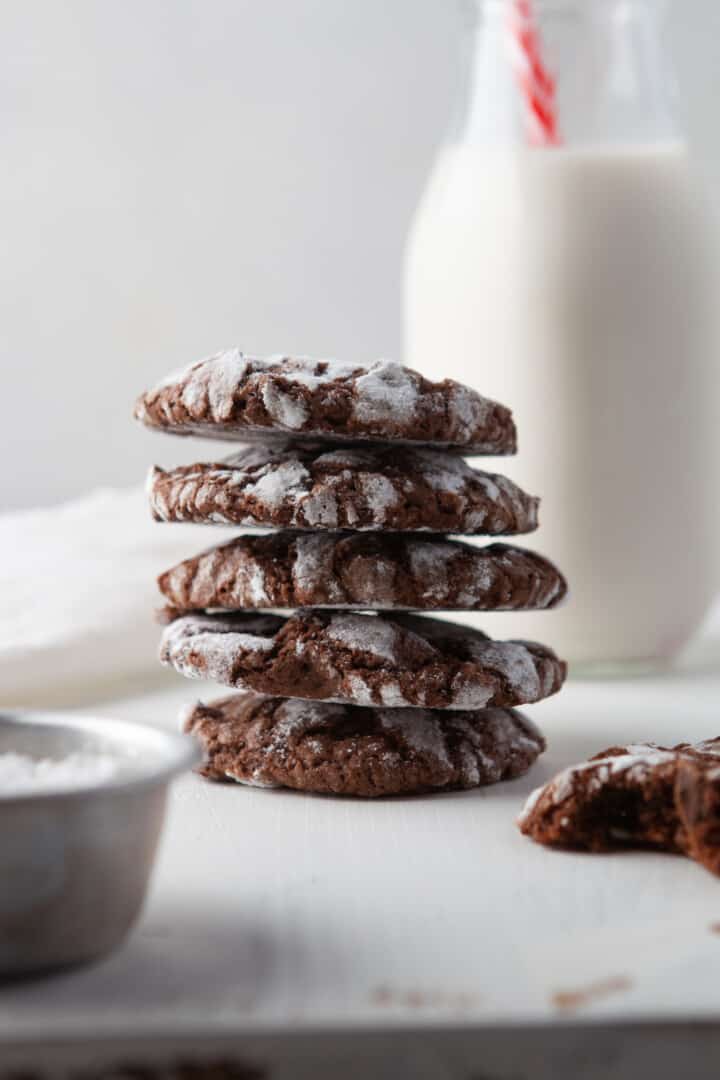 stacked chocolate crinkle cookies with milk