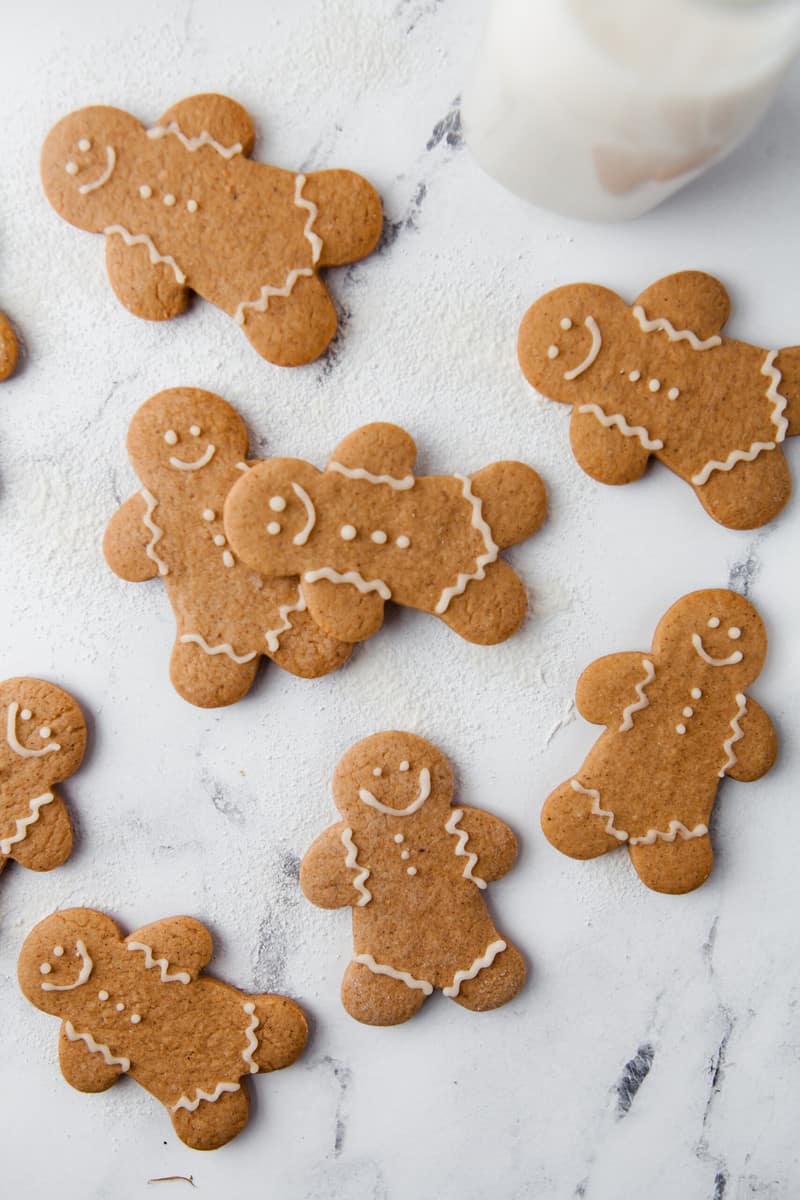 decorated gingerbread men on marble countertop