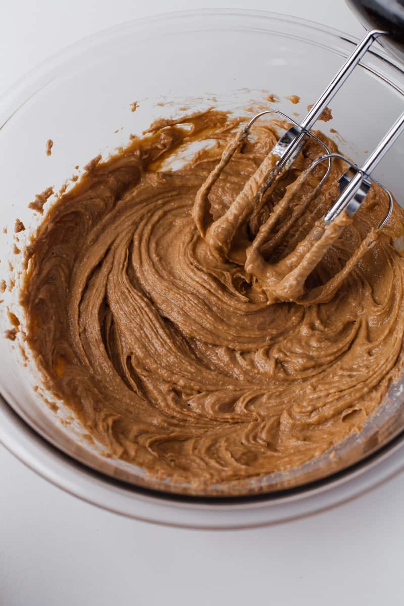 mixing together the wet ingredients for gingerbread cookies.