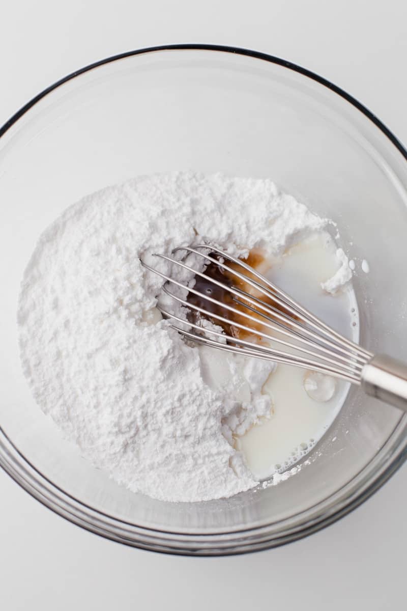 whisking together the ingredients for the icing