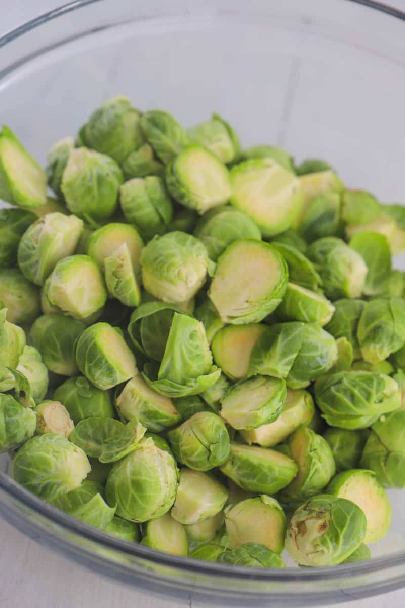sliced Brussel Sprouts in a glass mixing bowl
