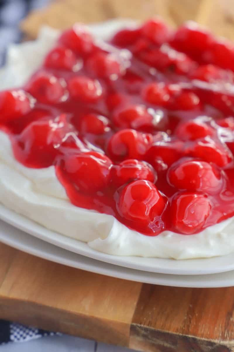 close up of cherry cheesecake dip on white plates