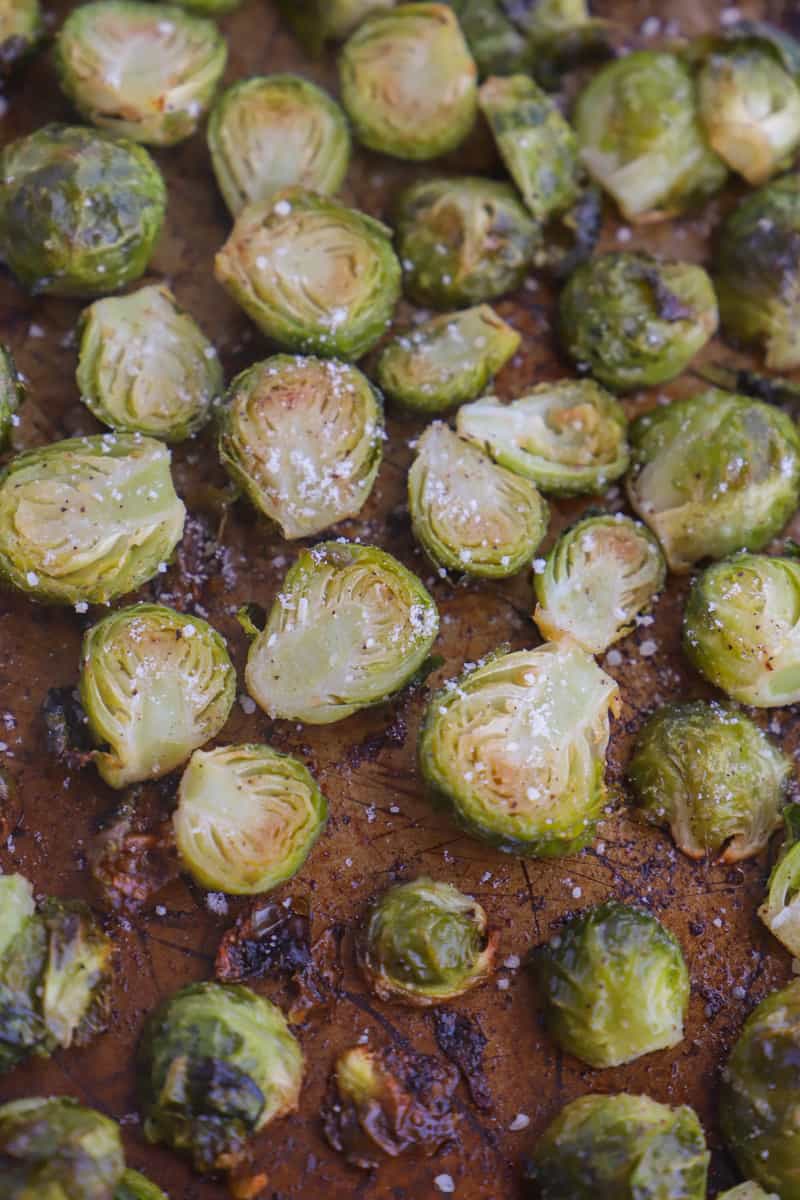 sprinkling Parmesan cheese on roasted Brussel Sprouts