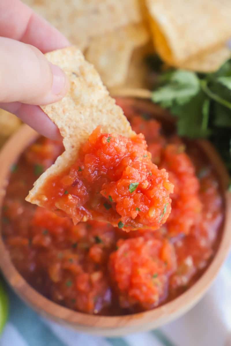 dipping a tortilla chip into the salsa