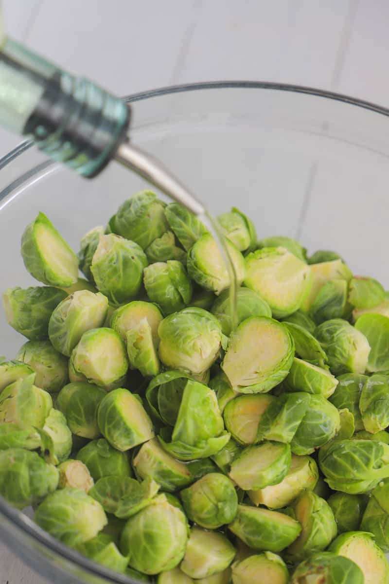covering and coating Brussel Sprouts in oil