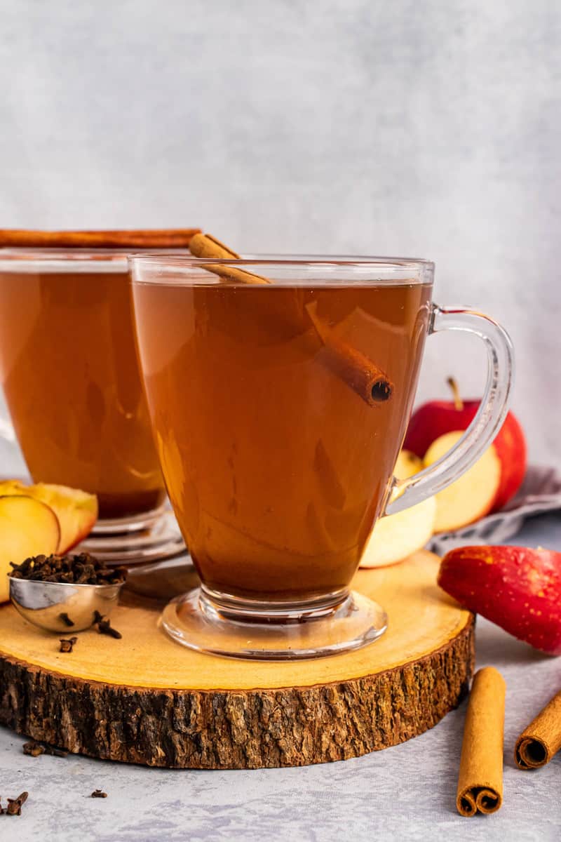 side view of slow cooker apple cider in glass mugs