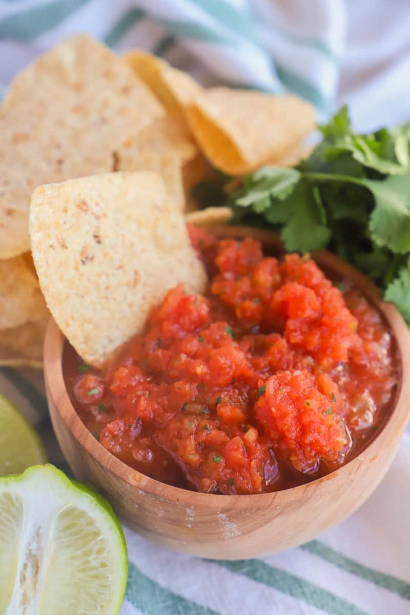 salsa in a wooden bowl served with tortilla chips