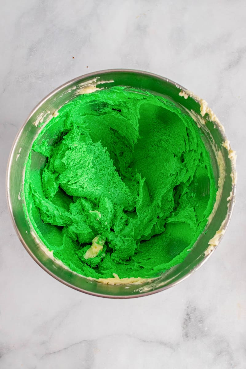 adding green dye to cookie dough
