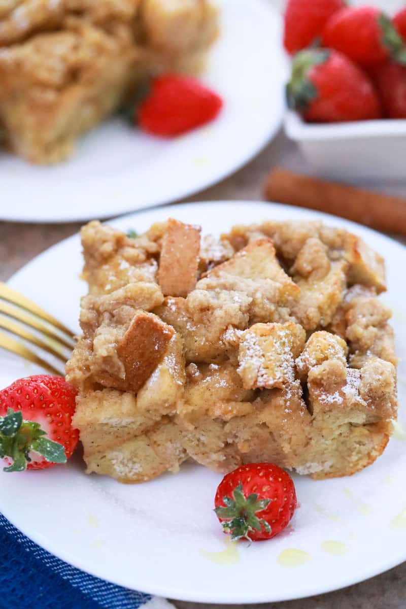 French Toast Casserole on white plate with strawberries