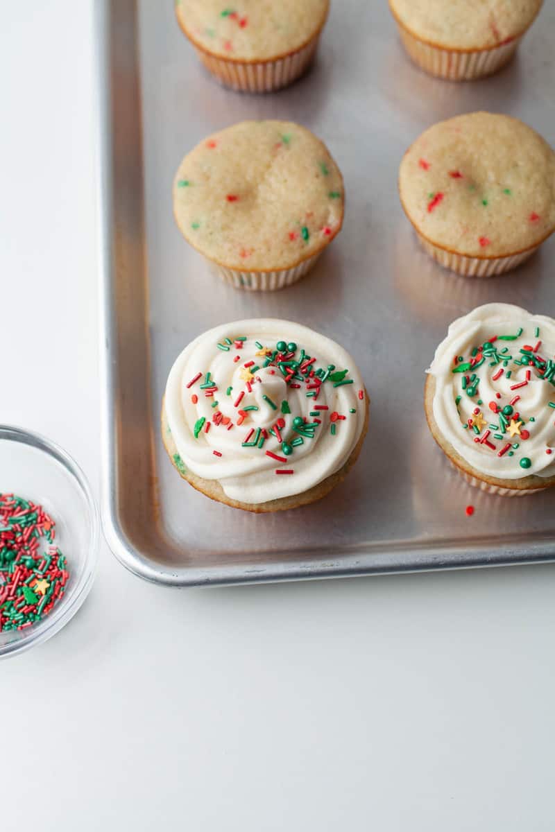 cupcakes on tray being iced