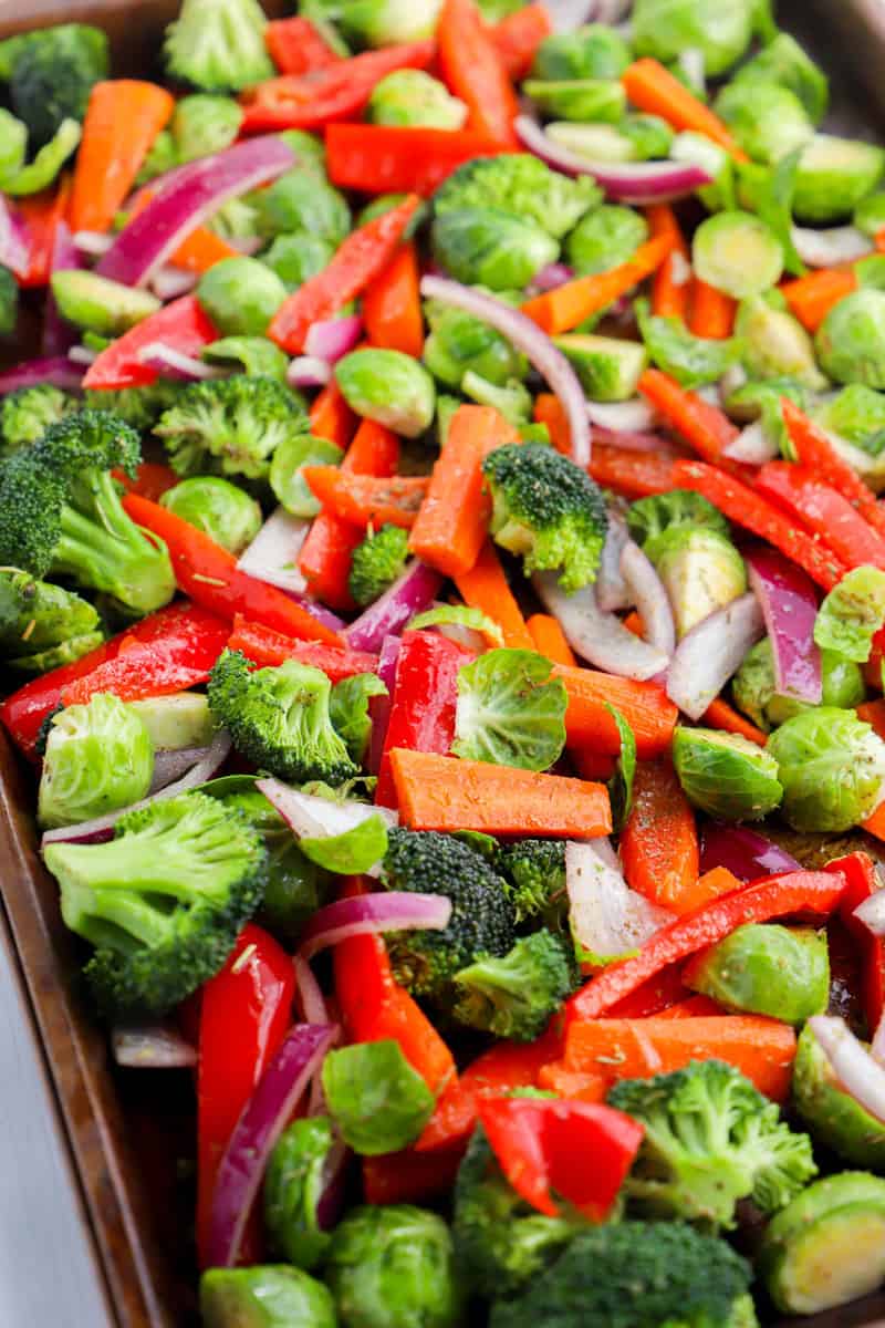 layering the vegetables on the baking sheet before baking