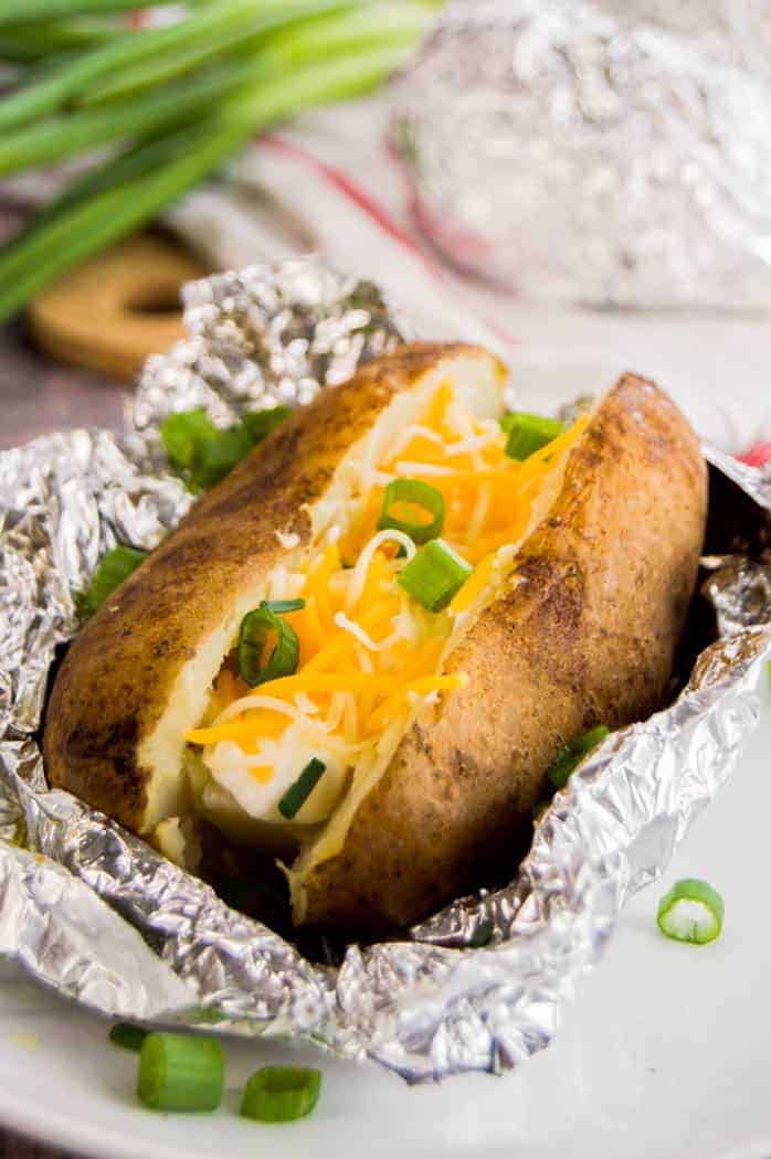 Slow Cooker Baked Potatoes in foil topped with cheese