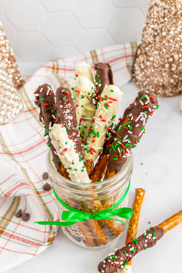 Chocolate covered pretzel rods in a mason jar.