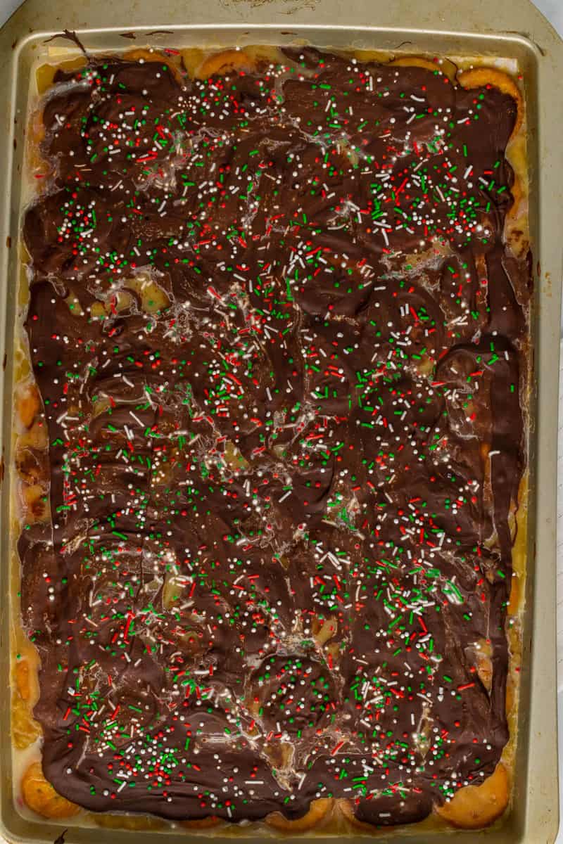 topping Christmas crack with sprinkles