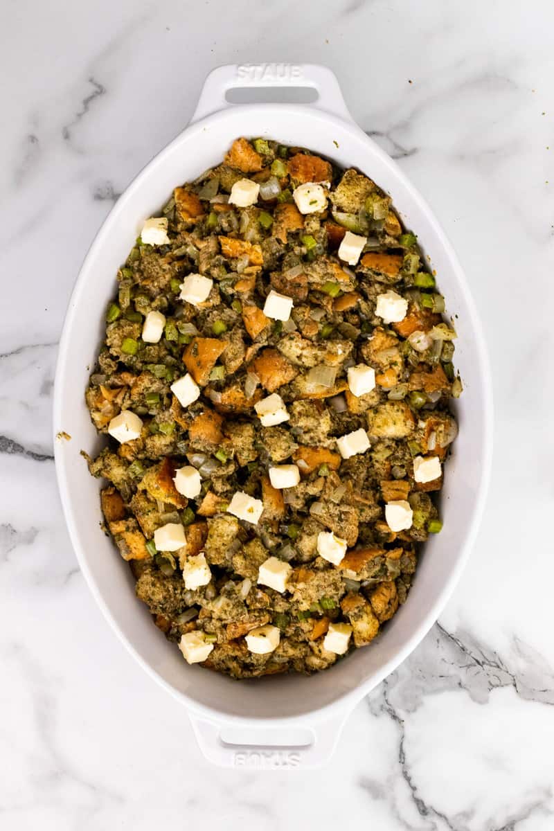 stuffing in casserole dish topped with butter