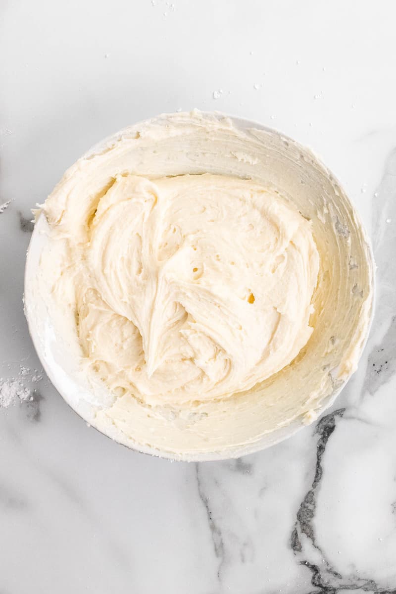 the buttercream frosting in white bowl