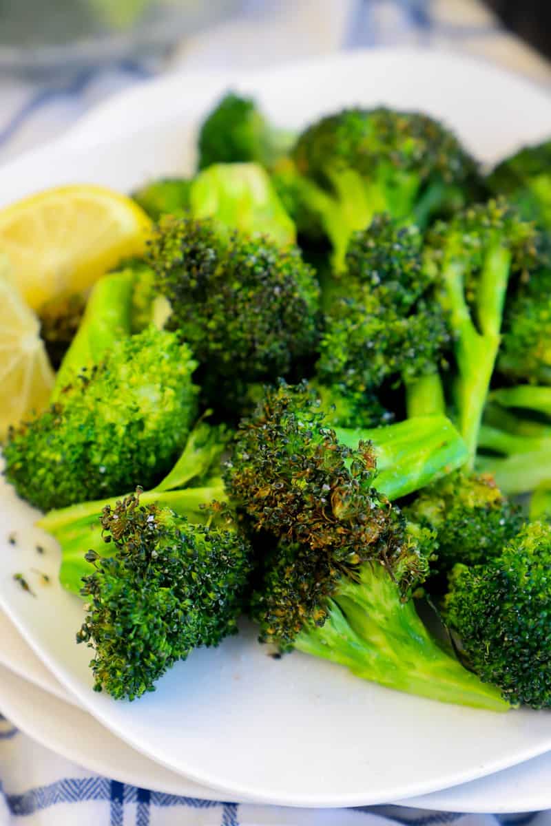 Air Fryer Broccoli on stacked white plates