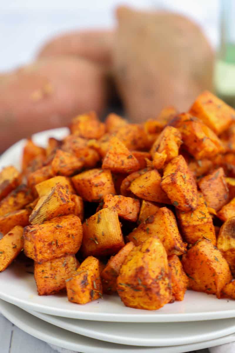 air fryer sweet potatoes on stacked white plates