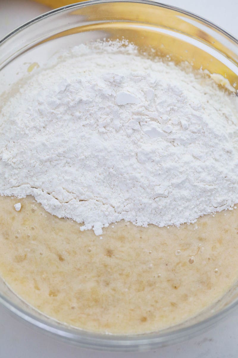 mixing together wet and dry ingredients for banana nut bread