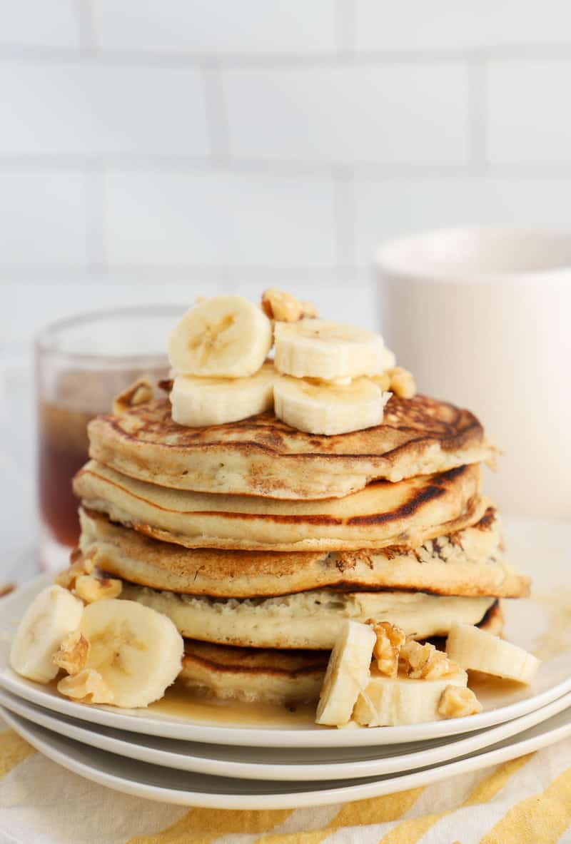 pancakes stacked topped with banana slices