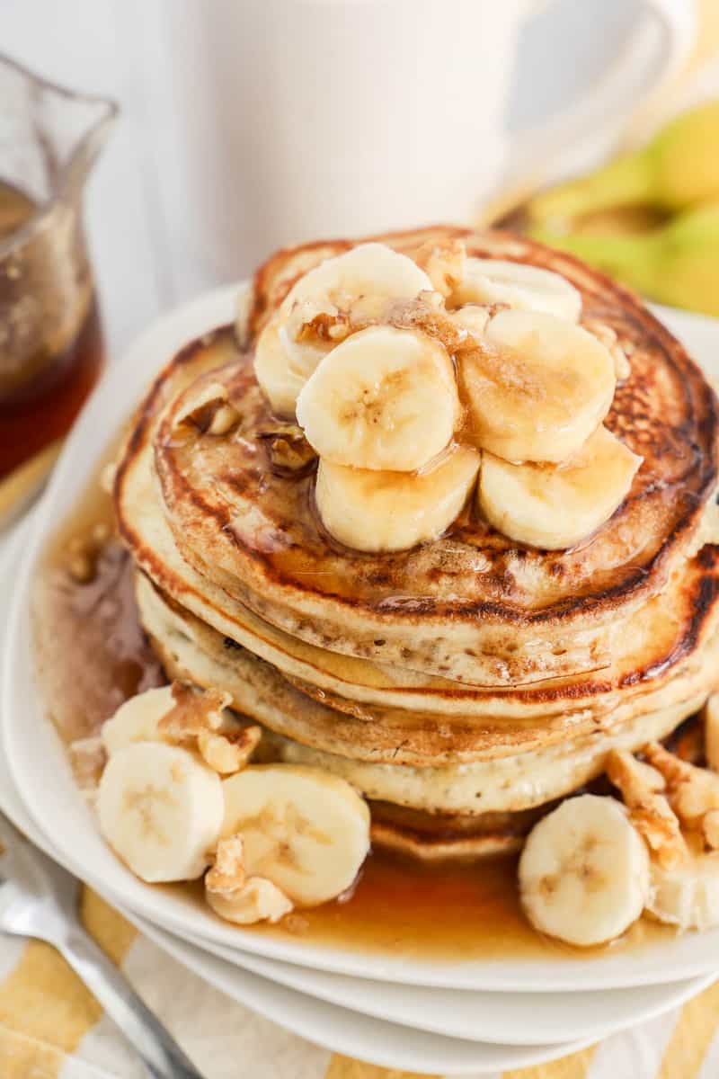 banana pancakes stacked and topped with banana slices