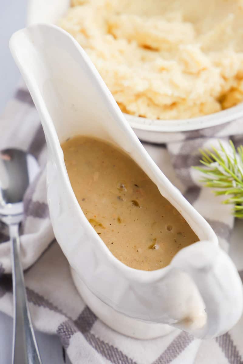 gravy in gravy boat with mashed potatoes in background