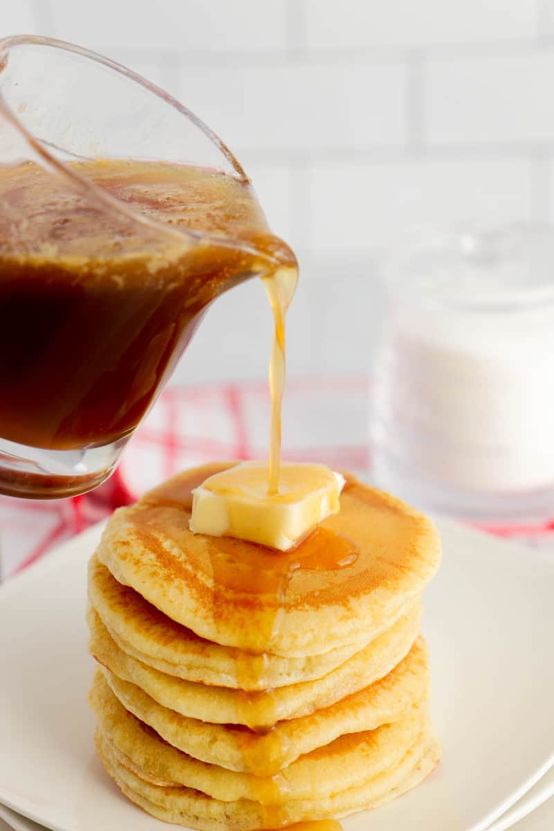 Homemade Pancake Syrup being poured over a stack of pancakes