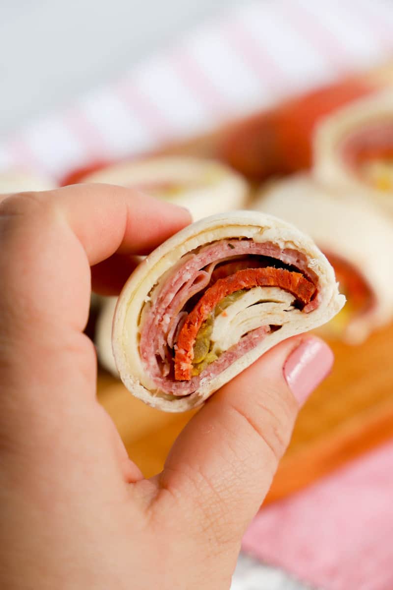 Italian pinwheels sliced and in hand.