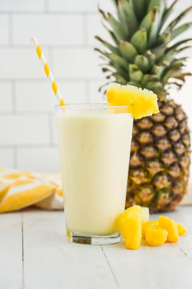 mango pineapple smoothie in glass with pineapple