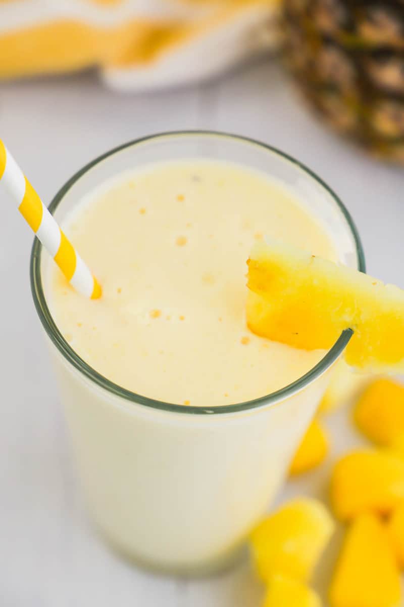 top closeup view of mango pineapple smoothie in glass