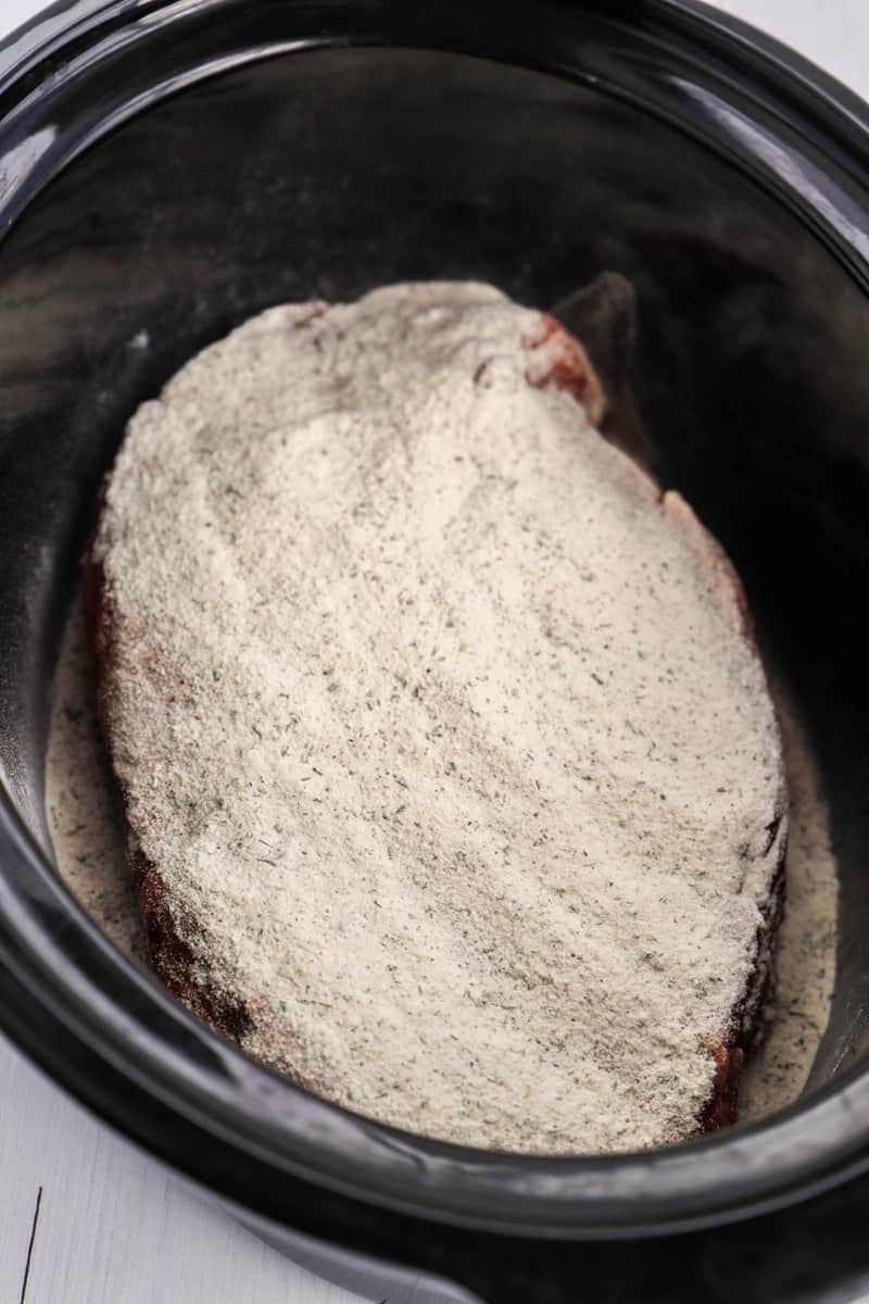 seasoning the chuck roast in the slow cooker