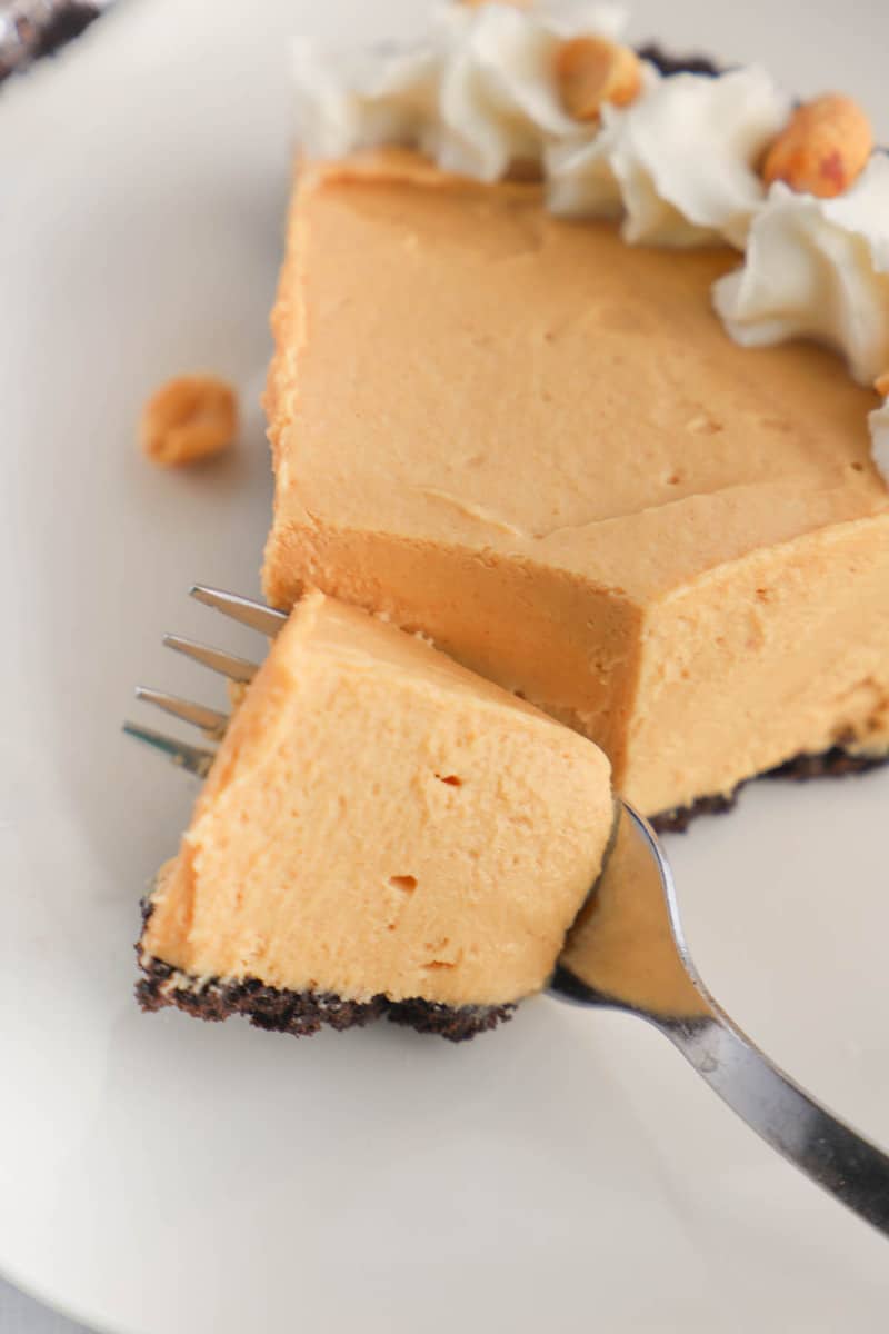closeup of peanut butter pie with fork cutting into it