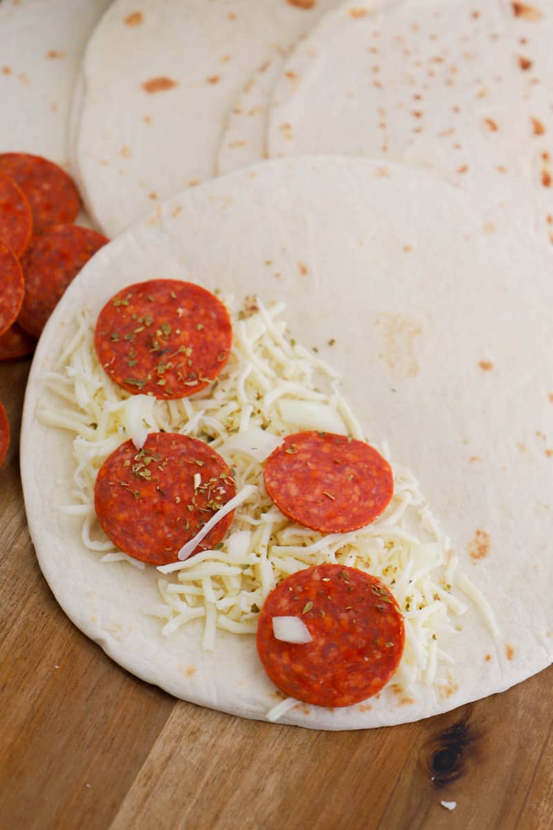 preparing the pizza quesadillas