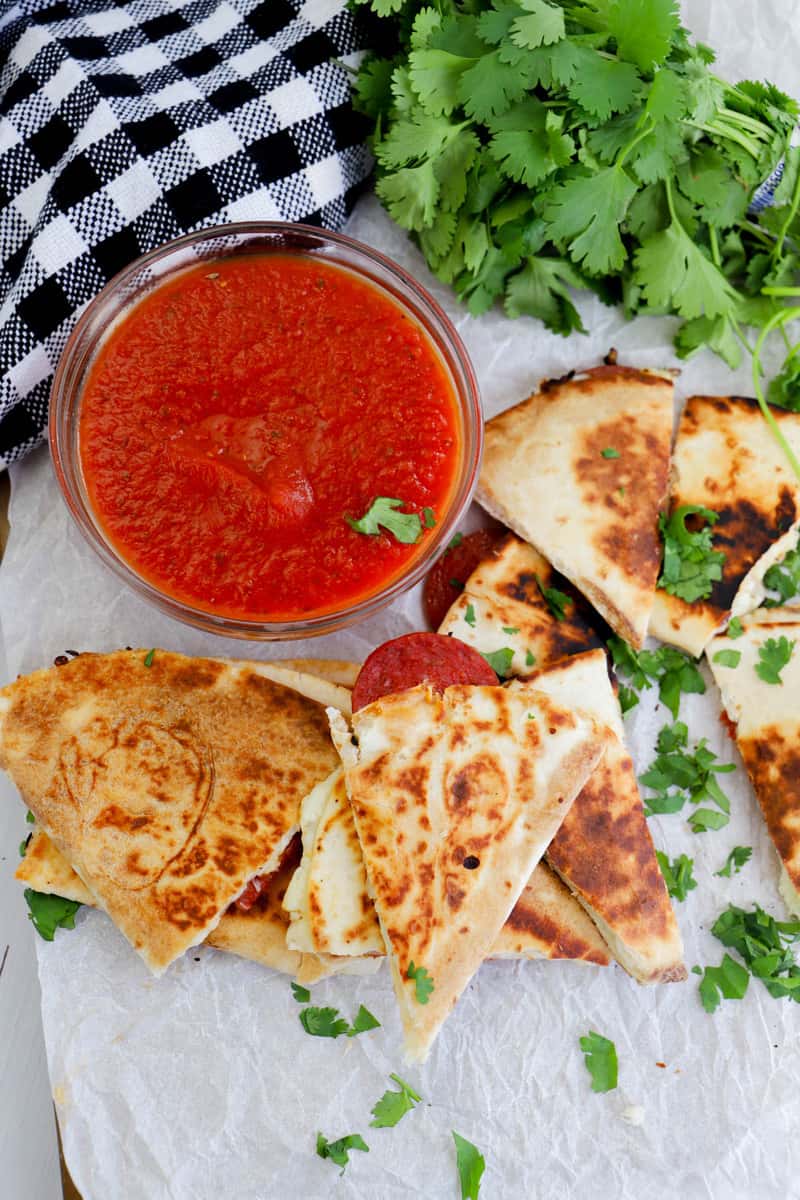 pizza quesadillas sliced with pizza dipping sauce