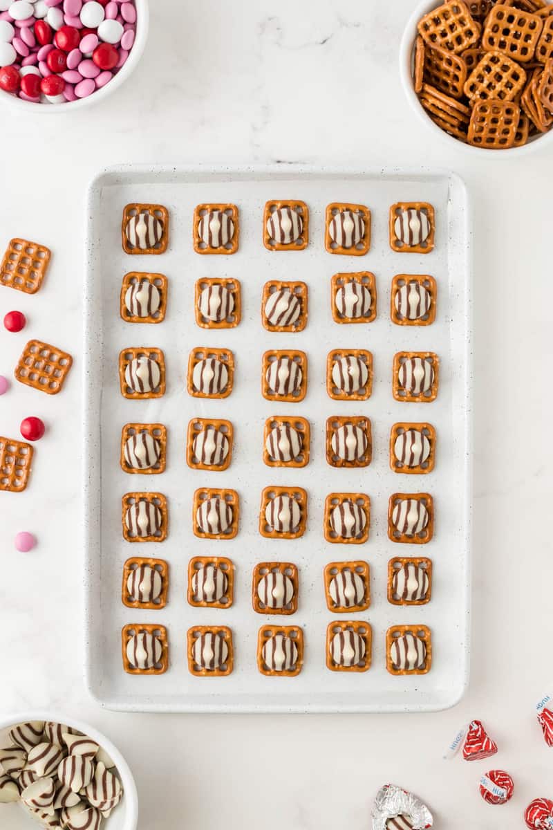 topping the pretzels with the hugs candies