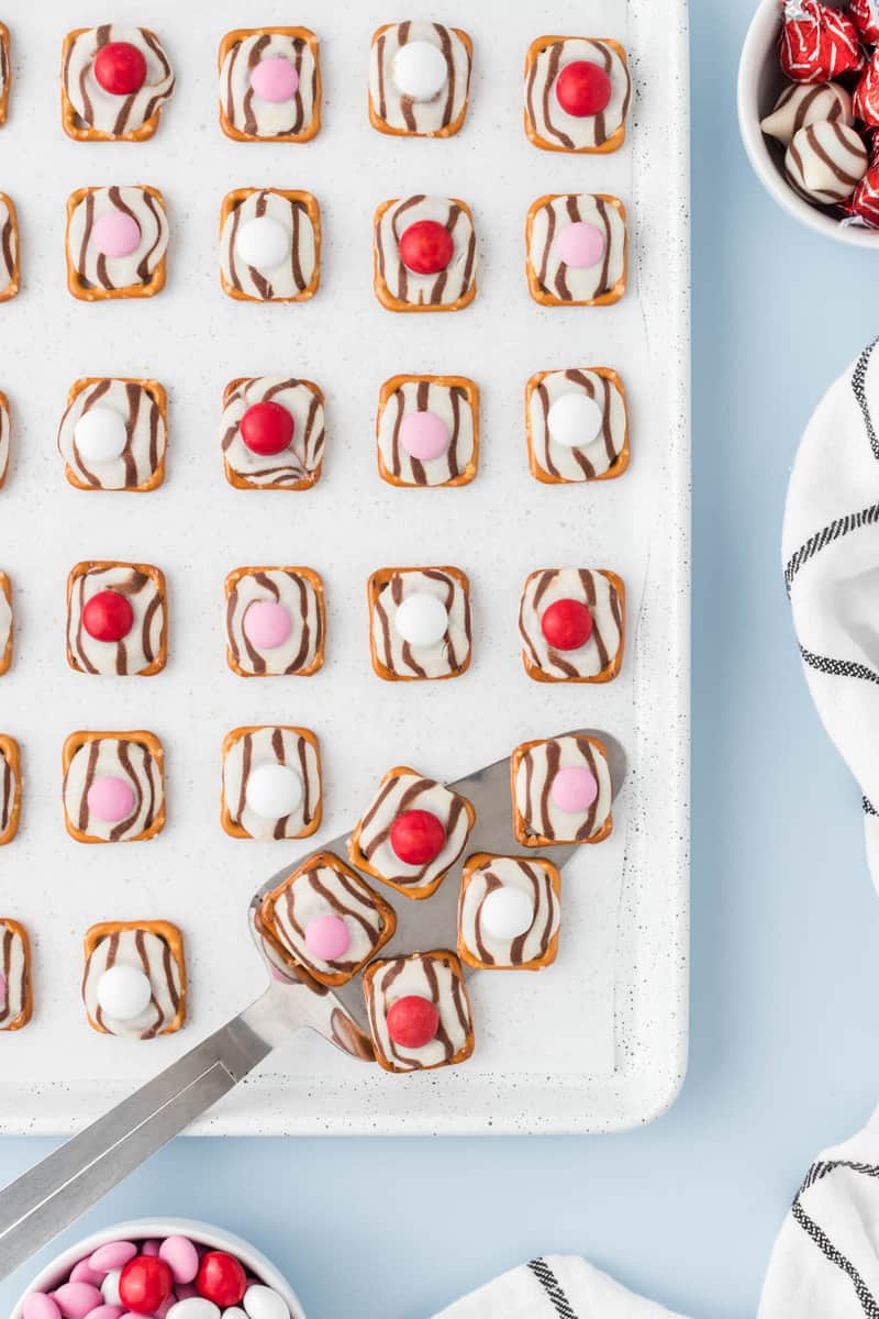 using a spatula to serve the pretzel hugs