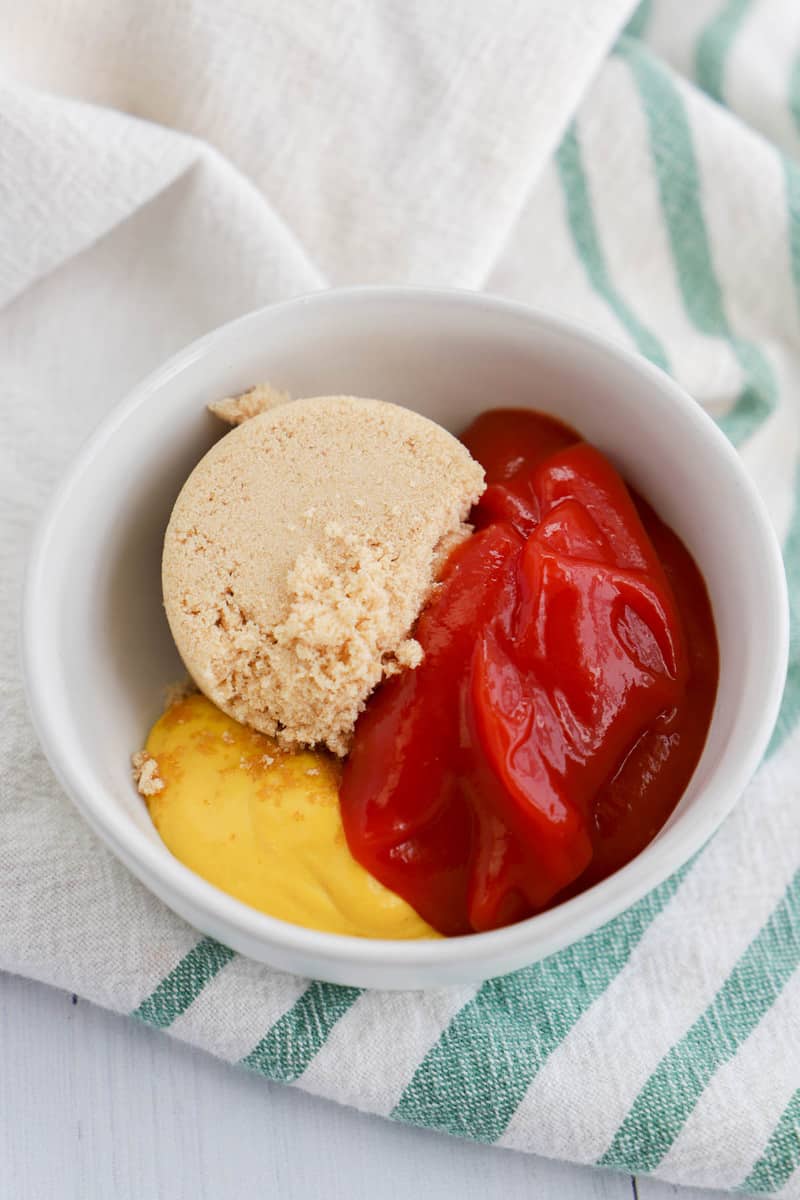 mixing ketchup mustard and brown sugar to make the topping