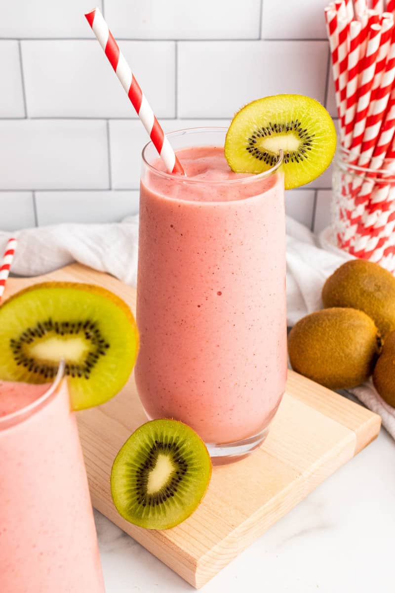 Strawberry Kiwi Smoothie in tall glass with kiwi