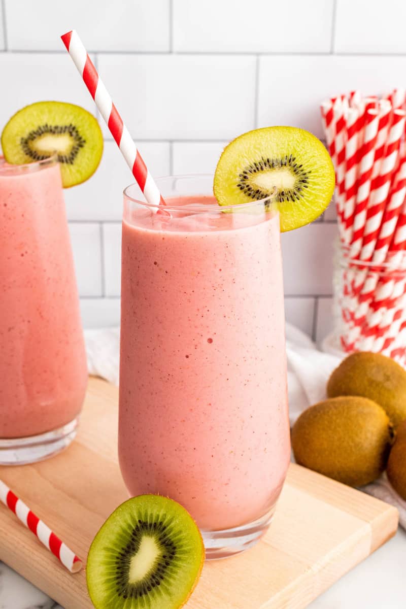 Strawberry Kiwi Smoothie in tall glass with kiwi slice