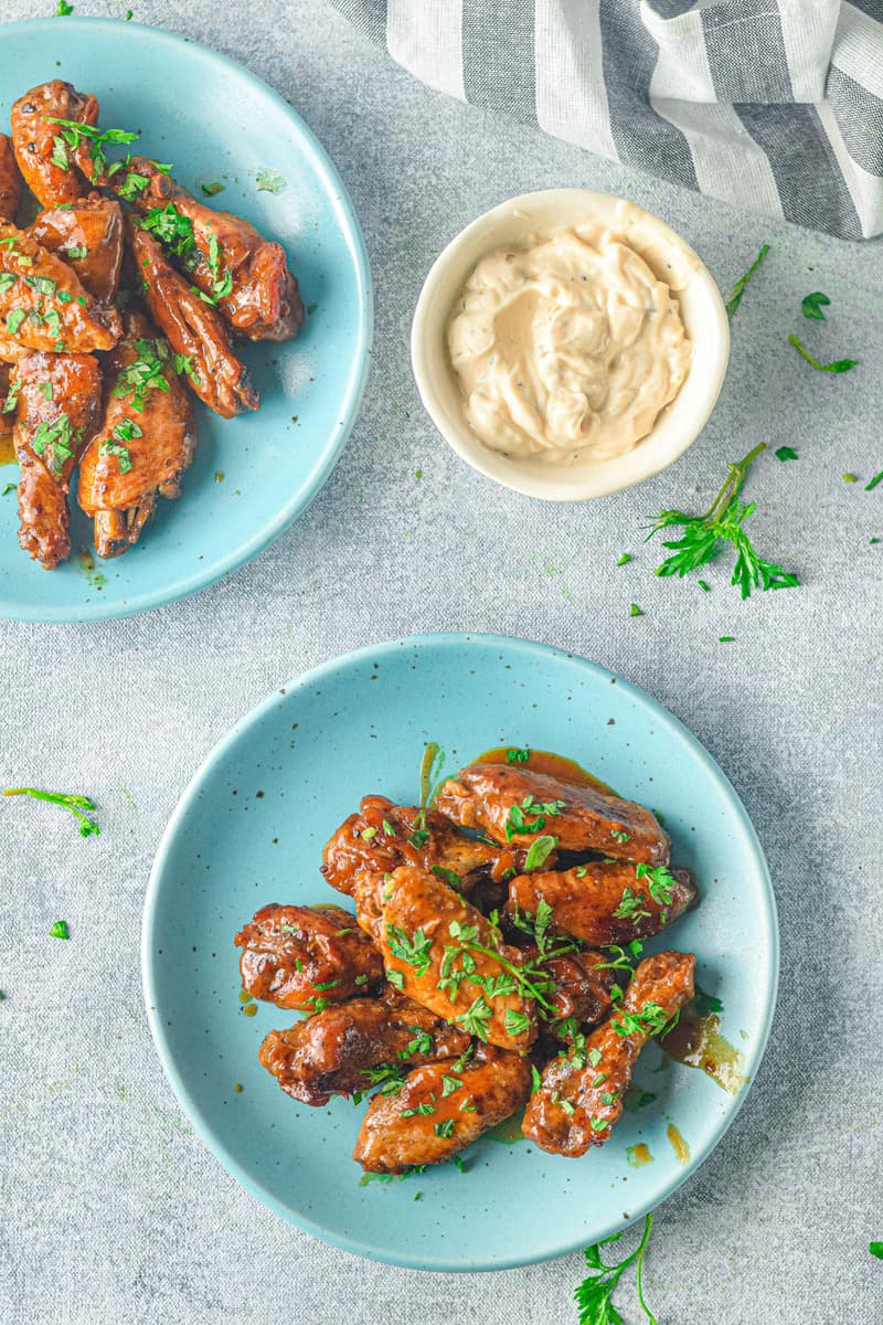 chicken wings served on blue plate with dipping sauce