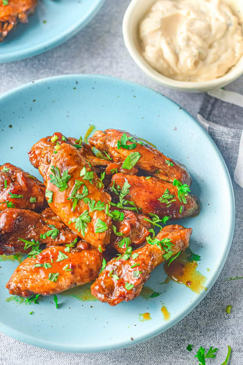 serving the instant pot chicken wings garnished with parsley